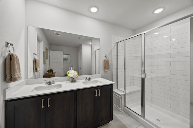 223 Exploration Way, Fate, TX 75189 - bathroom featuring a stall shower, tile patterned floors, double vanity, and recessed lighting