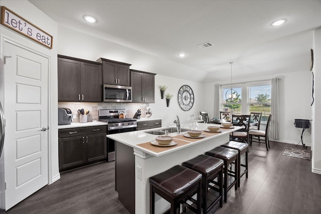 223 Exploration Way, Fate, TX 75189 - kitchen with stainless steel appliances, a sink, dark wood-type flooring, light countertops, and recessed lighting