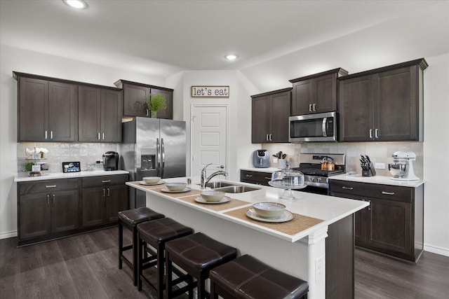 223 Exploration Way, Fate, TX 75189 - kitchen with a sink, stainless steel appliances, dark brown cabinetry, tasteful backsplash, and light countertops