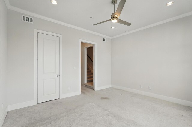 unfurnished bedroom with carpet, baseboards, crown molding, recessed lighting, and a ceiling fan