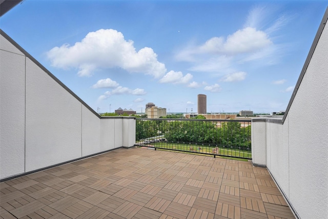 view of patio with a balcony and a view of city