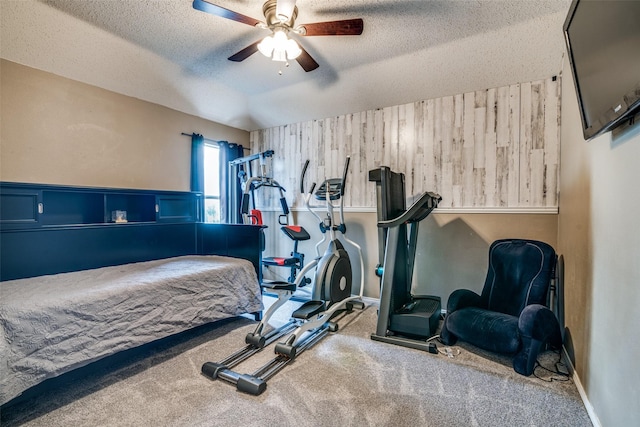 1407 Hickory Bend Dr, Allen, TX 75002 - workout room with a textured ceiling, ceiling fan, carpet flooring, and wooden walls