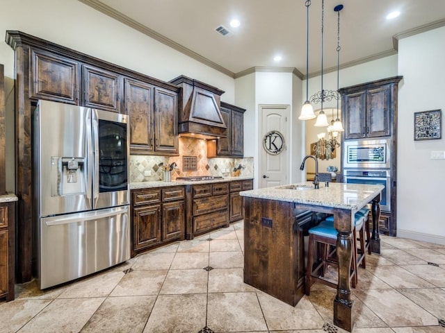 kitchen with appliances with stainless steel finishes, a sink, custom exhaust hood, light stone countertops, and backsplash