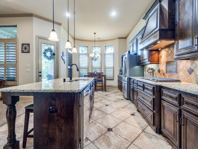 kitchen with a sink, appliances with stainless steel finishes, decorative backsplash, ornamental molding, and custom range hood