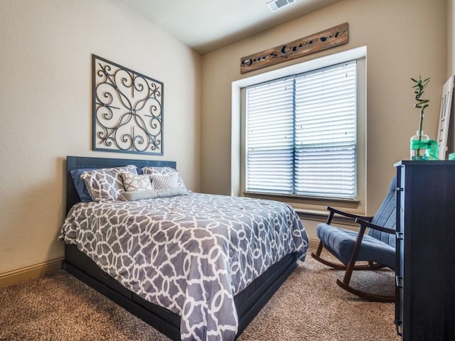bedroom with dark carpet and baseboards