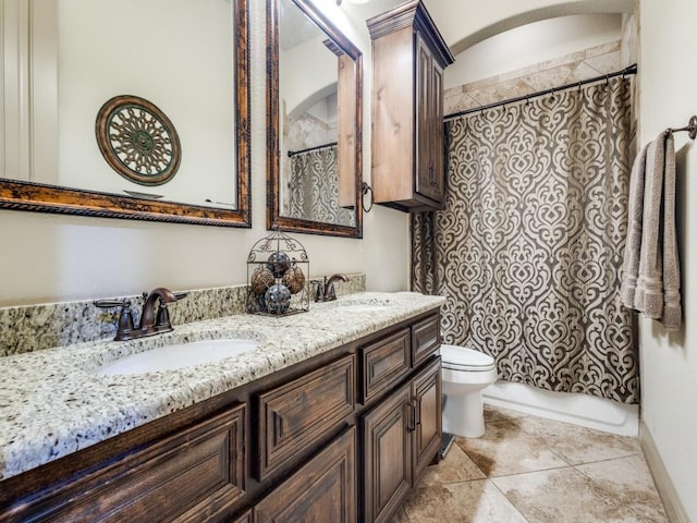 full bathroom with toilet and double vanity