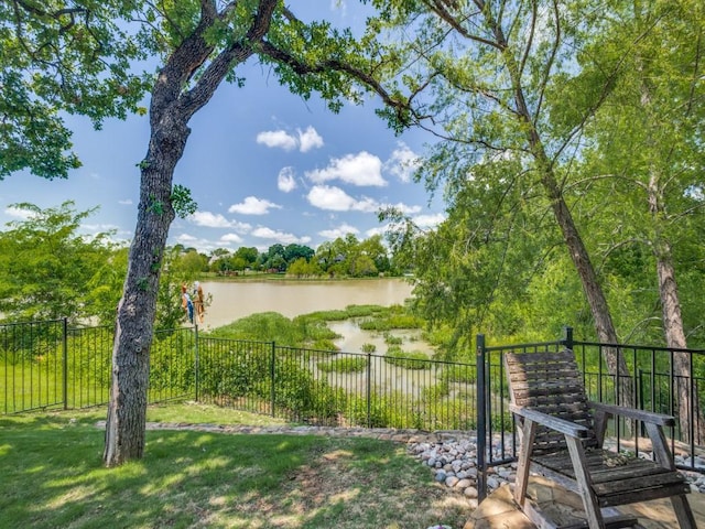 view of yard featuring a water view and fence