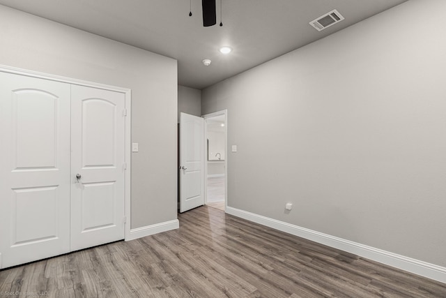 5585 Justine Pl, Fort Worth, TX 76126 - unfurnished bedroom with baseboards, wood finished floors, a closet, and a ceiling fan