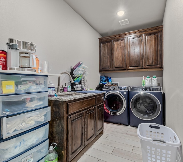 5585 Justine Pl, Fort Worth, TX 76126 - laundry room featuring cabinet space, washer and dryer, and light wood-style floors