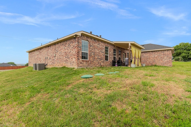 5585 Justine Pl, Fort Worth, TX 76126 - rear view of house featuring a yard, brick siding, and central air condition unit