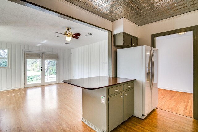 214 S Clark St, Rockwall, TX 75087 - kitchen with white refrigerator with ice dispenser, light wood finished floors, dark countertops, french doors, and open floor plan