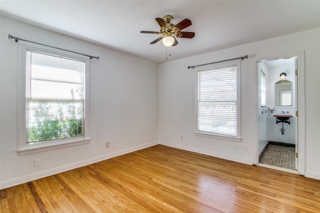 214 S Clark St, Rockwall, TX 75087 - empty room with light wood-type flooring, a ceiling fan, and baseboards