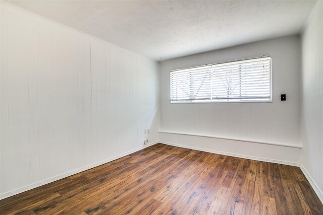 214 S Clark St, Rockwall, TX 75087 - spare room with dark wood-style flooring, ornamental molding, and baseboards