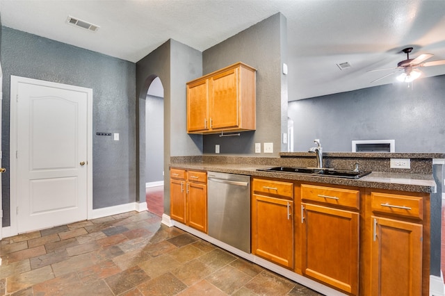 110 Commonwealth Cir, Waxahachie, TX 75165 - kitchen featuring dishwasher, a sink, arched walkways, a ceiling fan, and stone tile flooring