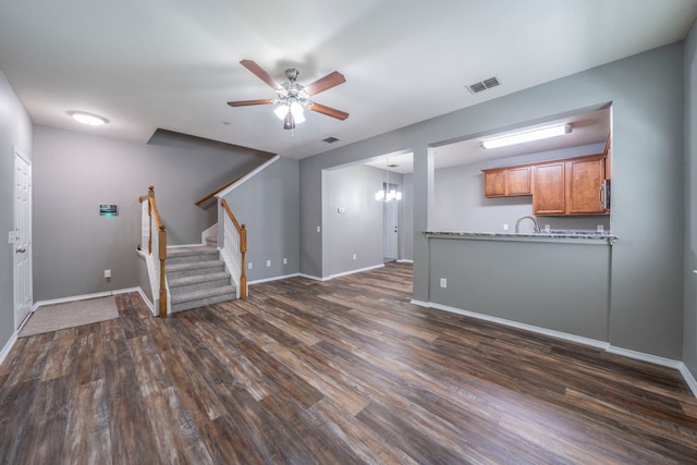 4928 Heather Glen Trl, Mckinney, TX 75070 - unfurnished living room featuring a ceiling fan, dark wood finished floors, stairs, and baseboards