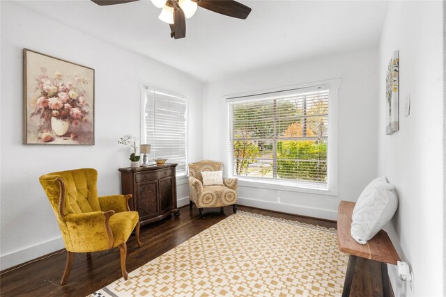 sitting room with dark wood-style flooring, ceiling fan, and baseboards