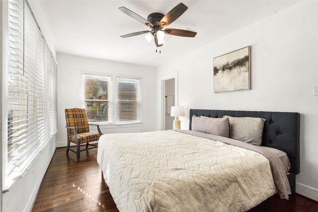 bedroom featuring wood finished floors, baseboards, and a ceiling fan