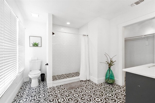 full bath featuring toilet, a stall shower, baseboards, tile patterned flooring, and recessed lighting