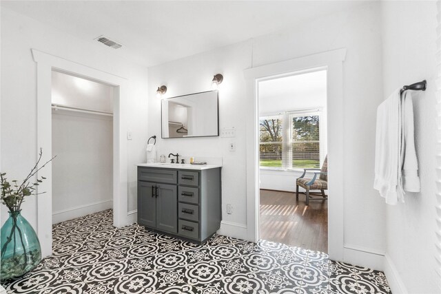 bathroom with baseboards and vanity