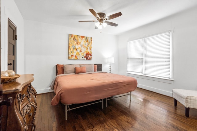 bedroom with baseboards, wood finished floors, and a ceiling fan