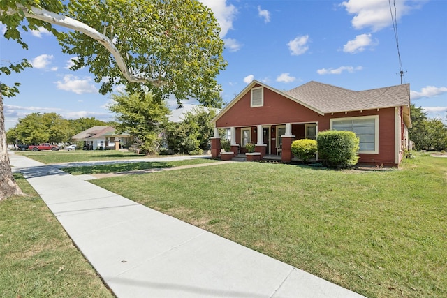 2511 Lipscomb St, Fort Worth, TX 76110 - bungalow-style home featuring a front yard, a shingled roof, and a porch