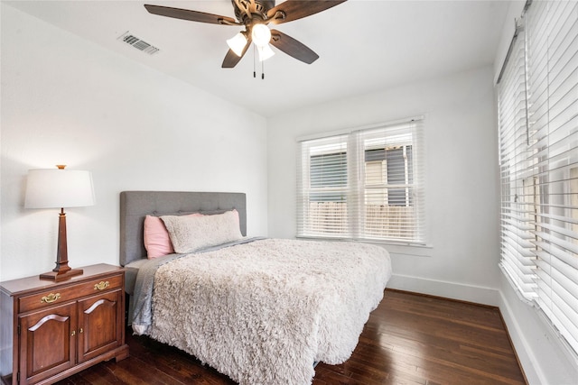 bedroom with dark wood-style flooring, baseboards, and a ceiling fan