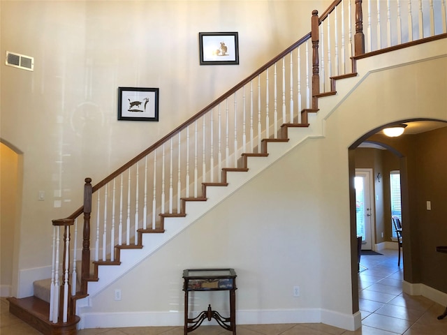 4210 Creek Falls Dr, Corinth, TX 76208 - staircase with arched walkways, tile patterned floors, and baseboards