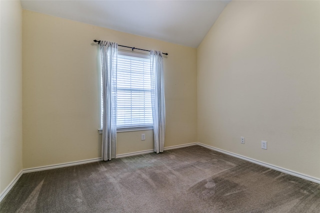 unfurnished room with carpet, baseboards, and lofted ceiling