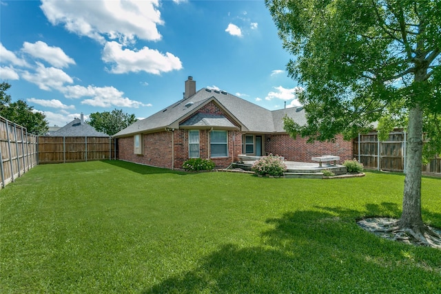 back of property featuring brick siding, a chimney, and a patio area