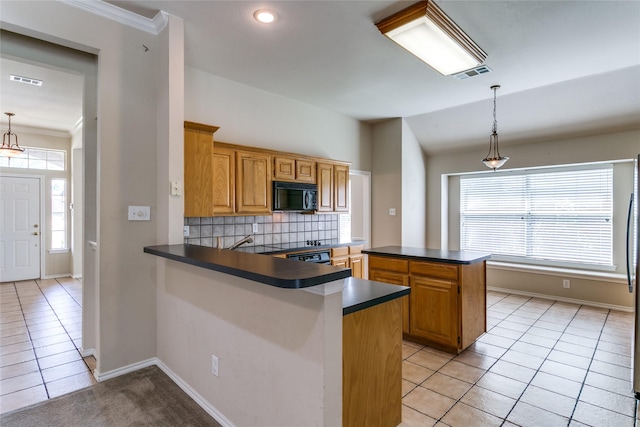 kitchen featuring black microwave, light tile patterned floors, backsplash, dark countertops, and crown molding