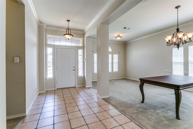 foyer with healthy amount of natural light, crown molding, baseboards, a chandelier, and light colored carpet