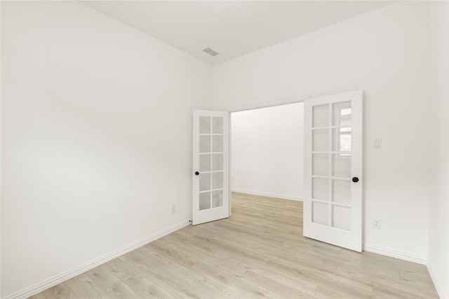 702 Roanoke, Princeton, TX 75407 - unfurnished room with french doors, light wood-type flooring, and baseboards