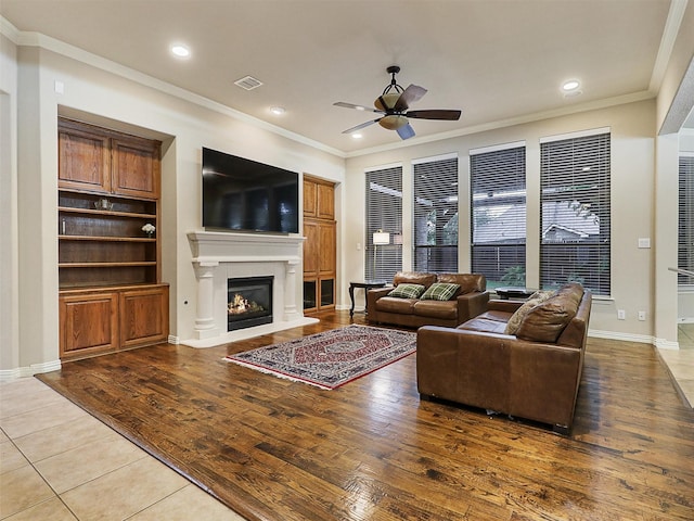 6769 Canal Ct, Grand Prairie, TX 75054 - living room featuring ceiling fan, a warm lit fireplace, crown molding, light wood-style floors, and recessed lighting
