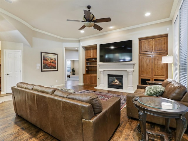 6769 Canal Ct, Grand Prairie, TX 75054 - living area with a ceiling fan, dark wood-style floors, ornamental molding, a glass covered fireplace, and recessed lighting