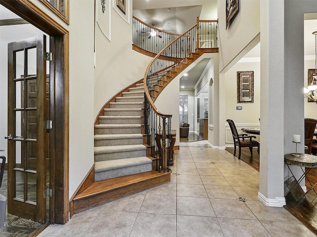 6769 Canal Ct, Grand Prairie, TX 75054 - foyer entrance with stairway, baseboards, tile patterned flooring, and a high ceiling