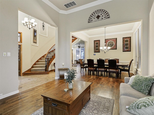 6769 Canal Ct, Grand Prairie, TX 75054 - living room with a chandelier, stairs, crown molding, wood finished floors, and baseboards