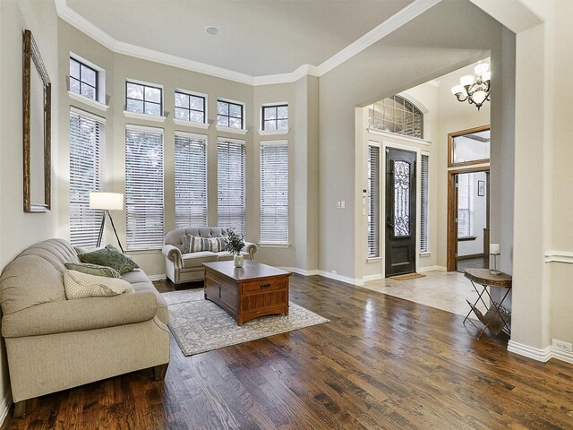 6769 Canal Ct, Grand Prairie, TX 75054 - living area with healthy amount of natural light, ornamental molding, wood finished floors, baseboards, and a chandelier