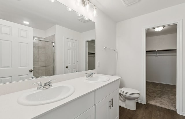 1053 Clear Dusk Ln, Forney, TX 75126 - full bath with a spacious closet, double vanity, a shower stall, and wood finished floors