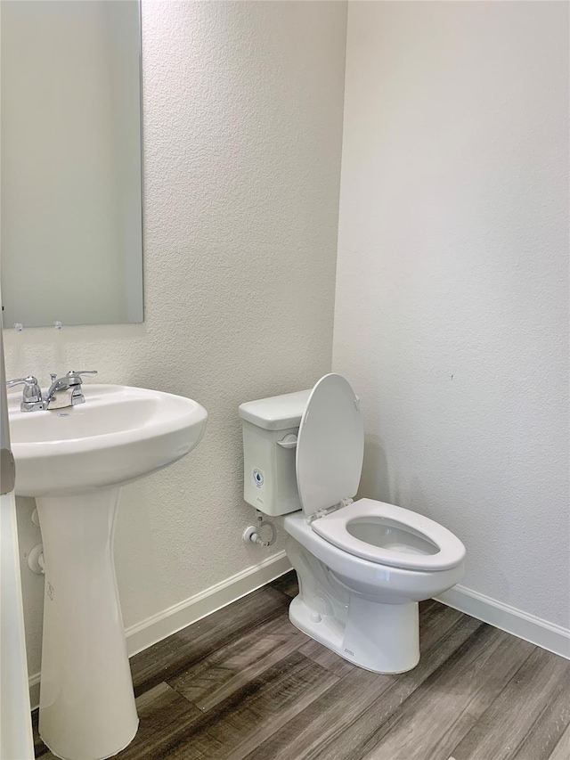 2617 Silver Leaf Ln, Anna, TX 75409 - half bath featuring baseboards, wood finished floors, toilet, and a sink