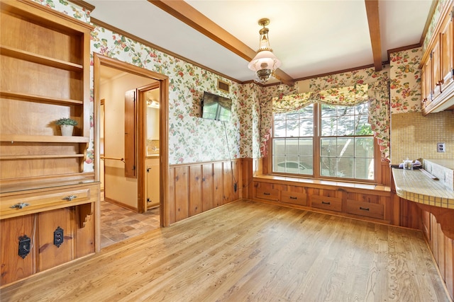 214 Country Club Rd, Hillsboro, TX 76645 - unfurnished dining area with wallpapered walls, a wainscoted wall, light wood-style flooring, and crown molding