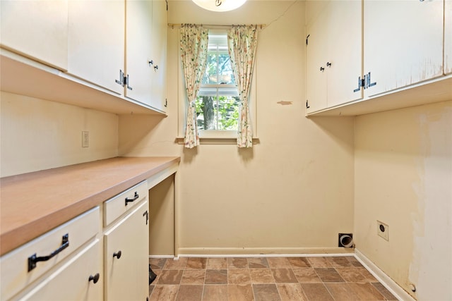 214 Country Club Rd, Hillsboro, TX 76645 - clothes washing area featuring baseboards, cabinet space, and electric dryer hookup
