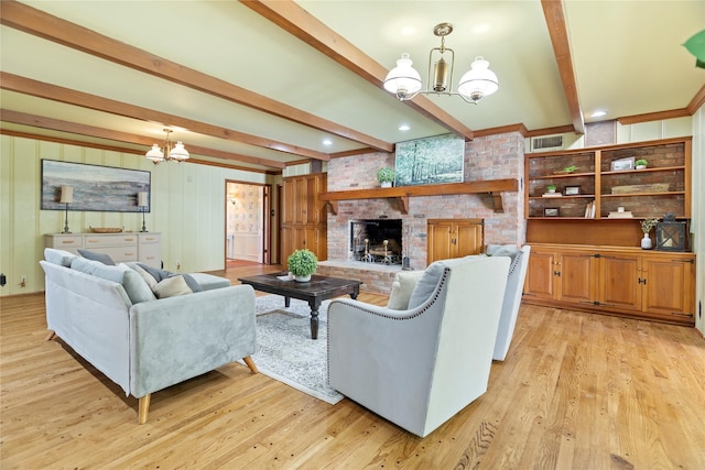 214 Country Club Rd, Hillsboro, TX 76645 - living area with a chandelier, beam ceiling, a brick fireplace, and light wood-style flooring