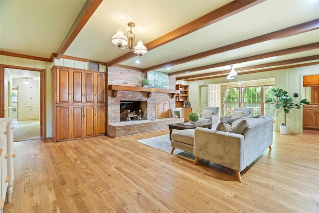 214 Country Club Rd, Hillsboro, TX 76645 - living area with beam ceiling, light wood-style floors, a fireplace, a chandelier, and a decorative wall