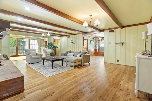 214 Country Club Rd, Hillsboro, TX 76645 - living room featuring a chandelier, wood finished floors, beamed ceiling, and wood walls