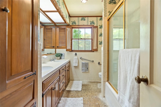 214 Country Club Rd, Hillsboro, TX 76645 - full bath featuring double vanity, crown molding, speckle patterned floor, shower / bath combination with glass door, and toilet