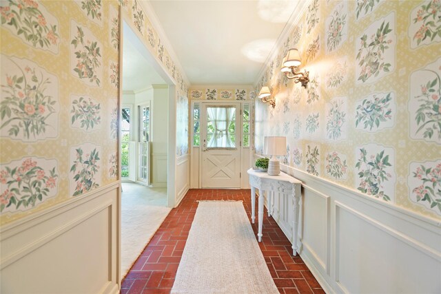 214 Country Club Rd, Hillsboro, TX 76645 - hall featuring wallpapered walls, brick flooring, a wainscoted wall, a decorative wall, and crown molding