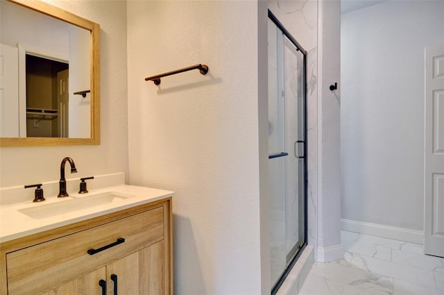4363 Lisbon St, Fort Worth, TX 76107 - bathroom featuring a shower stall, marble finish flooring, vanity, and a walk in closet