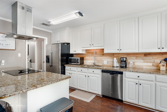 kitchen featuring stainless steel appliances, island range hood, a sink, ornamental molding, and white cabinetry