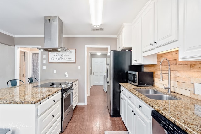 kitchen featuring stainless steel appliances, island exhaust hood, a sink, tasteful backsplash, and white cabinetry