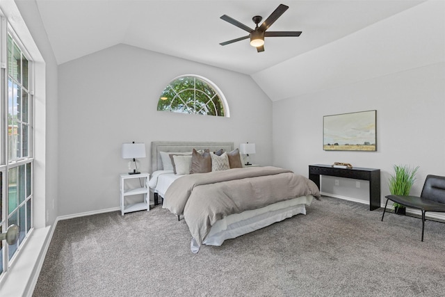 carpeted bedroom featuring lofted ceiling, baseboards, and ceiling fan